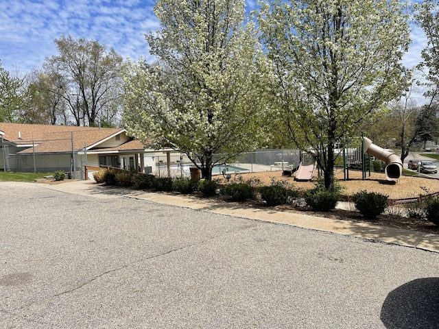 6922 Knotty Pine St NE, Rockford, MI 49341 - view of front facade featuring fence and driveway