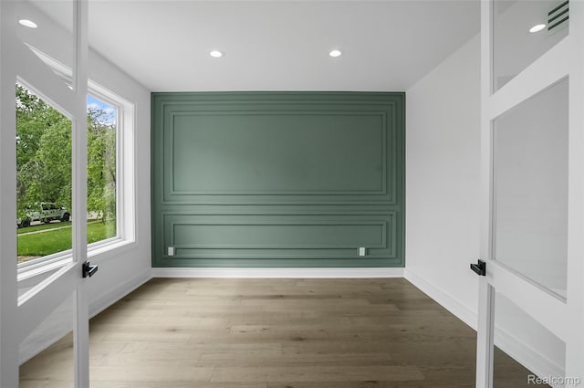 4112 Elmhurst Ave, Royal Oak, MI 48073 - spare room featuring baseboards, light wood-type flooring, recessed lighting, and a decorative wall