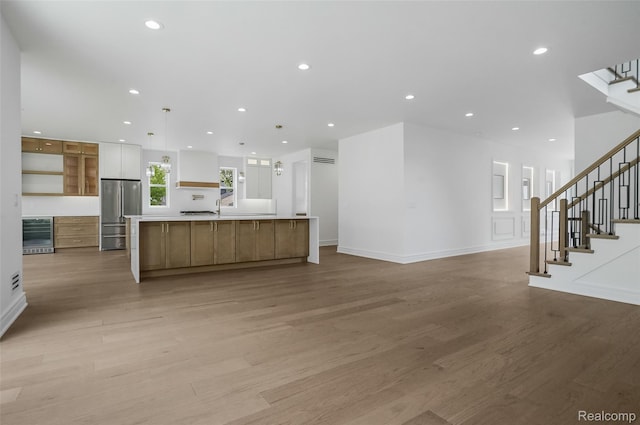 4112 Elmhurst Ave, Royal Oak, MI 48073 - unfurnished living room featuring stairway, light wood finished floors, beverage cooler, recessed lighting, and baseboards