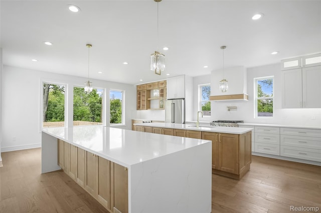 4112 Elmhurst Ave, Royal Oak, MI 48073 - kitchen featuring a spacious island, high end refrigerator, a sink, recessed lighting, and light wood-type flooring