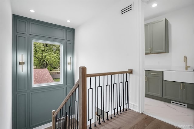 4112 Elmhurst Ave, Royal Oak, MI 48073 - corridor with a sink, an upstairs landing, wood finished floors, recessed lighting, and baseboards