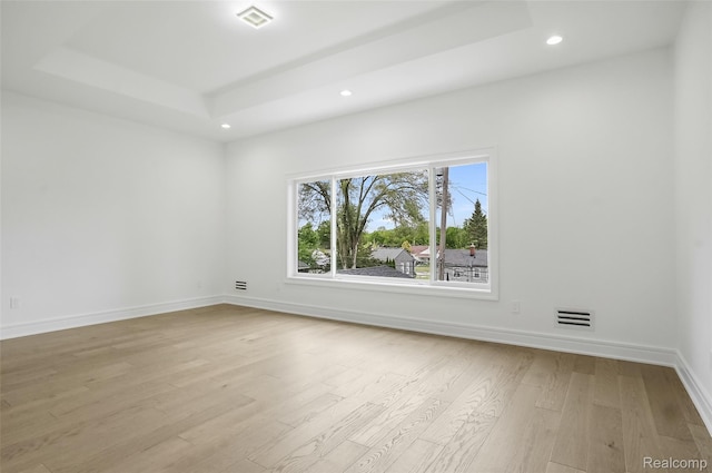 4112 Elmhurst Ave, Royal Oak, MI 48073 - empty room featuring a tray ceiling, recessed lighting, wood finished floors, and baseboards