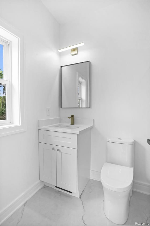 4112 Elmhurst Ave, Royal Oak, MI 48073 - bathroom with marble finish floors, baseboards, vanity, and toilet