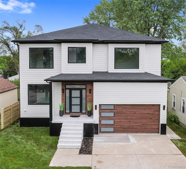 4112 Elmhurst Ave, Royal Oak, MI 48073 - modern home featuring concrete driveway, a garage, and a shingled roof