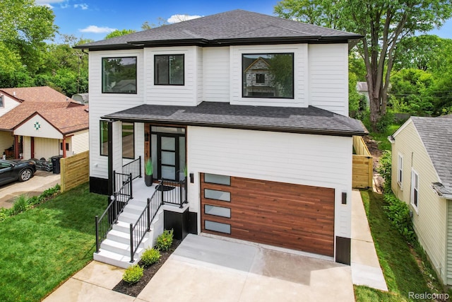 4112 Elmhurst Ave, Royal Oak, MI 48073 - contemporary home featuring an attached garage, driveway, and roof with shingles