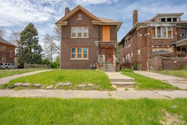 view of front facade with a chimney and brick siding