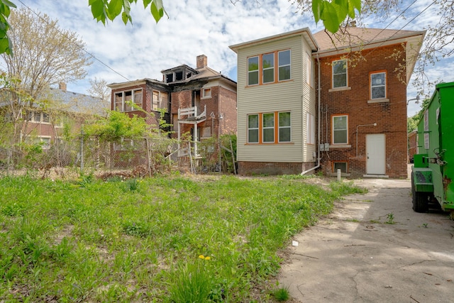 back of property featuring fence