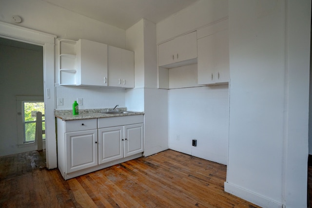 kitchen with light wood-style floors, white cabinets, open shelves, and a sink