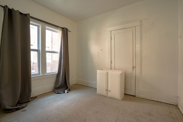 unfurnished room featuring baseboards