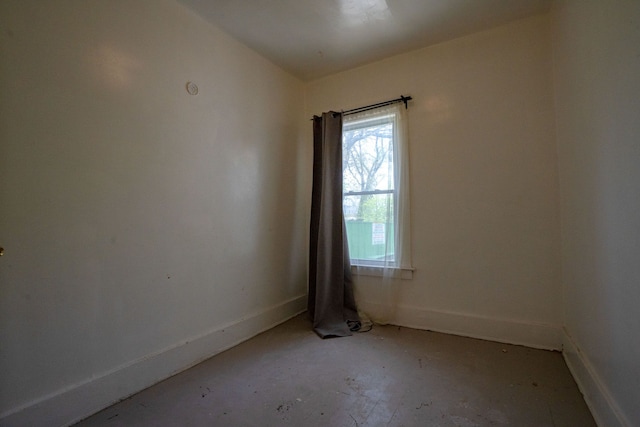 unfurnished room featuring baseboards