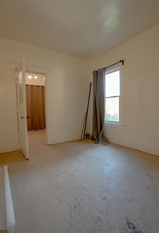 unfurnished room featuring baseboards and light wood-style flooring