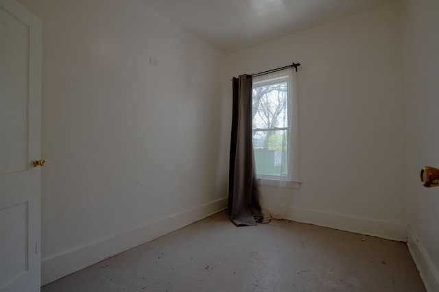 spare room featuring baseboards