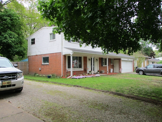 7140 Ridgedale Ln, Lambertville, MI 48144 - view of front of property featuring brick siding, an attached garage, a porch, and driveway