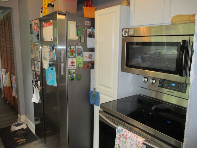 7140 Ridgedale Ln, Lambertville, MI 48144 - kitchen with appliances with stainless steel finishes and white cabinetry