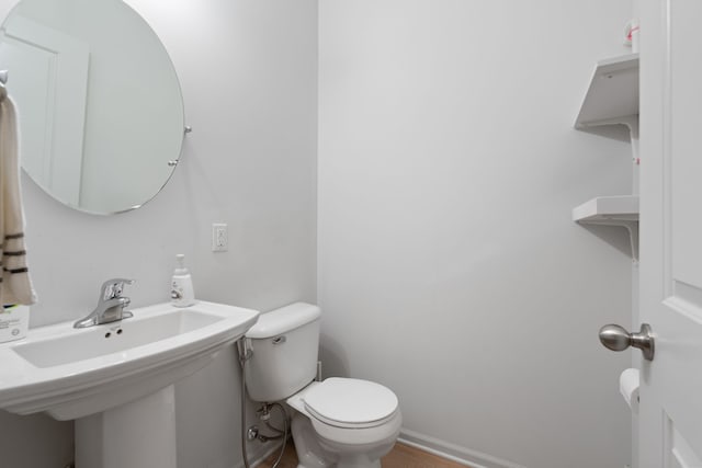 1071 N Sherman Dr Unit B, Royal Oak, MI 48067 - bathroom featuring toilet, a sink, baseboards, and wood finished floors