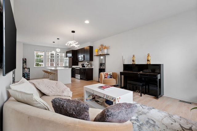 1071 N Sherman Dr Unit B, Royal Oak, MI 48067 - living area featuring light wood-type flooring, recessed lighting, baseboards, and a chandelier