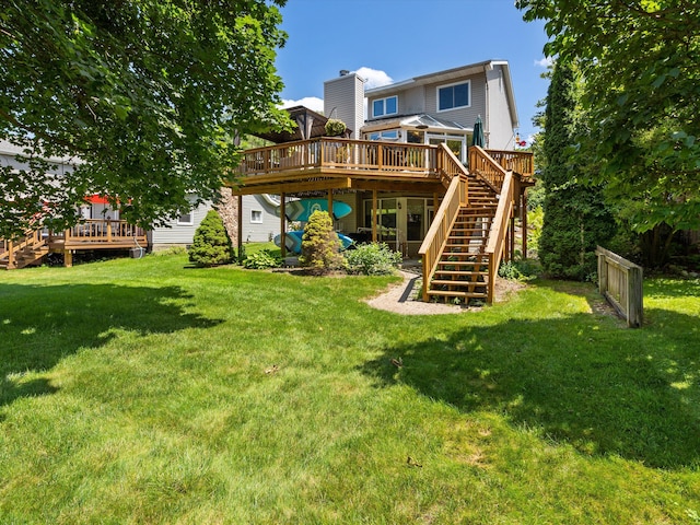 3097 Lansdowne Rd, Waterford, MI 48329 - rear view of house with a wooden deck, stairs, and a lawn