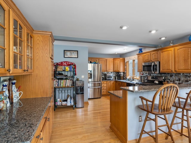 3097 Lansdowne Rd, Waterford, MI 48329 - kitchen with appliances with stainless steel finishes, a sink, tasteful backsplash, dark stone countertops, and recessed lighting
