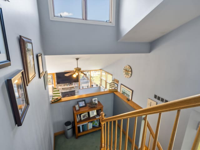 3097 Lansdowne Rd, Waterford, MI 48329 - stairway featuring carpet, plenty of natural light, and ceiling fan