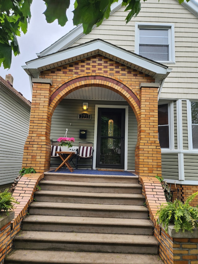 2713 Trowbridge St, Hamtramck, MI 48212 - property entrance with covered porch and brick siding