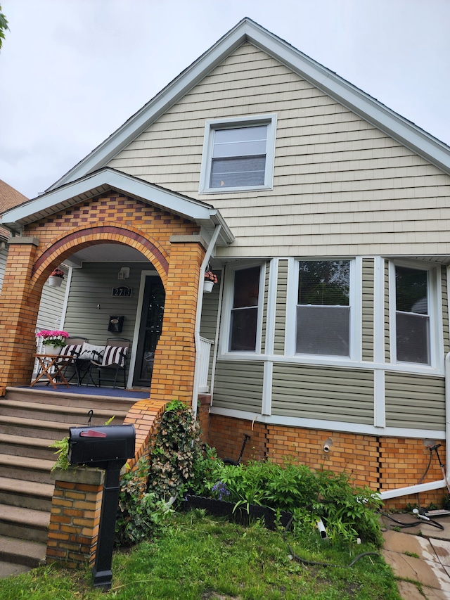 2713 Trowbridge St, Hamtramck, MI 48212 - view of front of house with a porch and brick siding