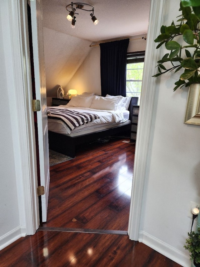 2713 Trowbridge St, Hamtramck, MI 48212 - bedroom with wood finished floors, vaulted ceiling, and baseboards