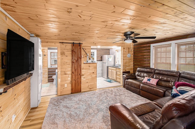 116 Alma Ln, Houghton Lake, MI 48629 - living room with wooden ceiling, a ceiling fan, light wood-style floors, a barn door, and log walls