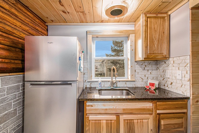 116 Alma Ln, Houghton Lake, MI 48629 - kitchen with freestanding refrigerator, a sink, wood ceiling, backsplash, and dark stone countertops