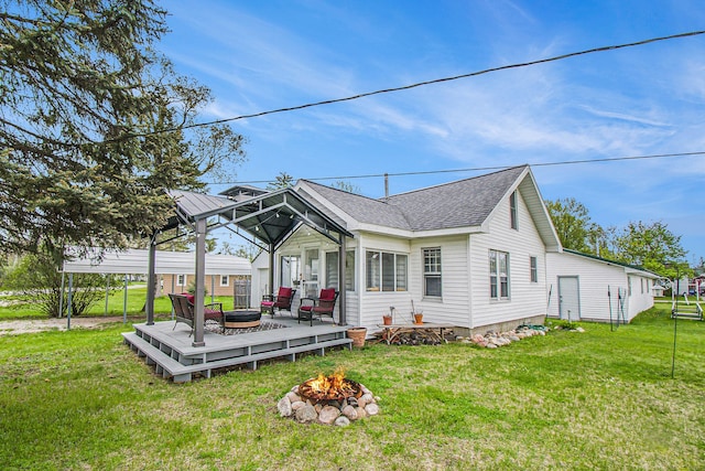 116 Alma Ln, Houghton Lake, MI 48629 - rear view of property with an outdoor fire pit, a lawn, and a wooden deck