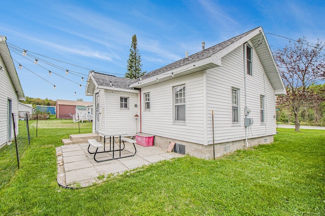 116 Alma Ln, Houghton Lake, MI 48629 - rear view of house with a patio and a shingled roof