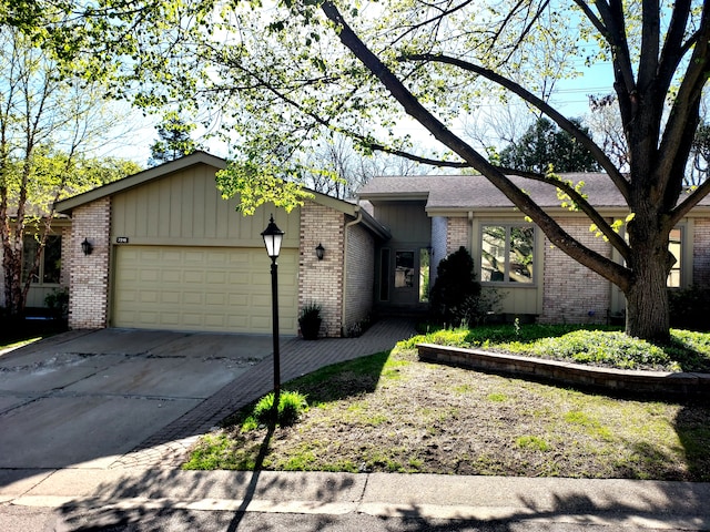 7215 Suncrest Rd, West Bloomfield, MI 48322 - view of front of house with brick siding, an attached garage, and driveway