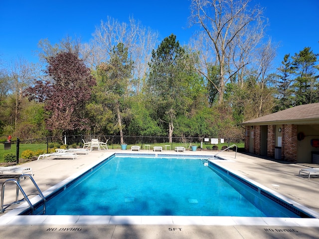 7215 Suncrest Rd, West Bloomfield, MI 48322 - community pool featuring a patio area, fence, and view of scattered trees