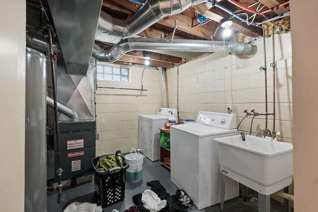 laundry room featuring washing machine and dryer and concrete block wall