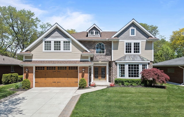 680 Pear Tree Ln, Grosse Pointe Woods, MI 48236 - view of front of home featuring french doors, a front lawn, driveway, an attached garage, and stone siding
