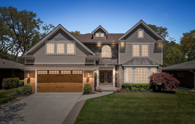 680 Pear Tree Ln, Grosse Pointe Woods, MI 48236 - view of front of house with a front yard, driveway, french doors, an attached garage, and stone siding