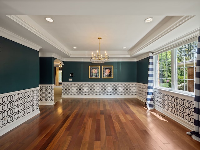 680 Pear Tree Ln, Grosse Pointe Woods, MI 48236 - empty room featuring a raised ceiling, a chandelier, wood-type flooring, a wainscoted wall, and ornamental molding