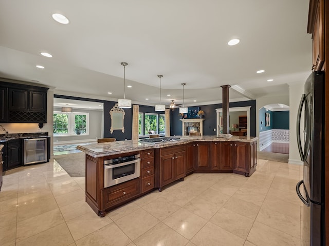 680 Pear Tree Ln, Grosse Pointe Woods, MI 48236 - kitchen featuring stainless steel appliances, wine cooler, light stone countertops, recessed lighting, and pendant lighting