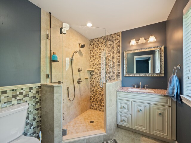 680 Pear Tree Ln, Grosse Pointe Woods, MI 48236 - bathroom with a stall shower, toilet, vanity, tile patterned floors, and tile walls