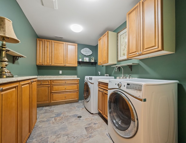 680 Pear Tree Ln, Grosse Pointe Woods, MI 48236 - laundry area with cabinet space, washing machine and clothes dryer, and light stone finish floors