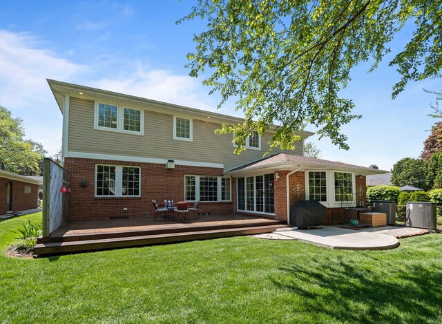 680 Pear Tree Ln, Grosse Pointe Woods, MI 48236 - back of property with brick siding, a wooden deck, a lawn, and a patio