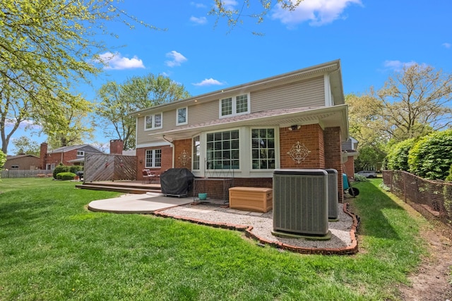 680 Pear Tree Ln, Grosse Pointe Woods, MI 48236 - back of house featuring brick siding, central AC unit, a deck, and a patio area