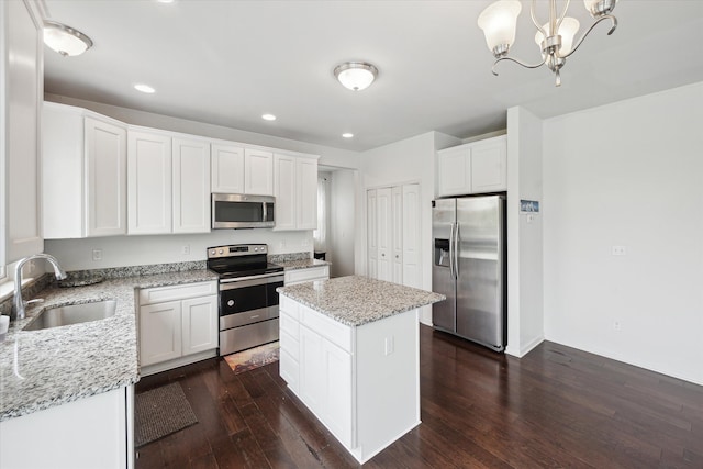 3236 Curtis, Wixom, MI 48393 - kitchen with stainless steel appliances, a sink, dark wood-type flooring, a kitchen island, and white cabinets