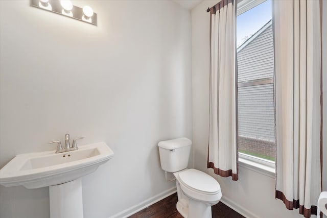 3236 Curtis, Wixom, MI 48393 - half bath featuring toilet, baseboards, a sink, and wood finished floors