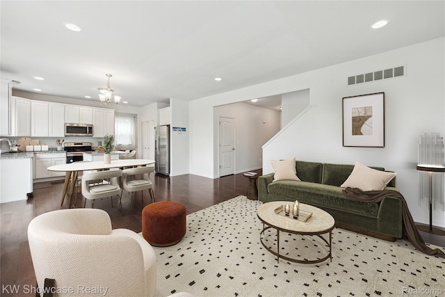 3236 Curtis, Wixom, MI 48393 - living room featuring recessed lighting, a chandelier, and wood finished floors