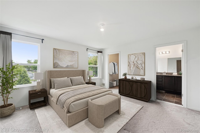 3236 Curtis, Wixom, MI 48393 - bedroom with light colored carpet, a walk in closet, and ensuite bath