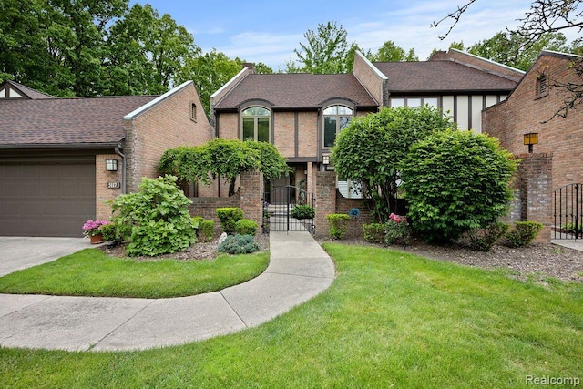 5117 Woodview Ct, Dearborn, MI 48126 - tudor house featuring brick siding, a front yard, a gate, and roof with shingles