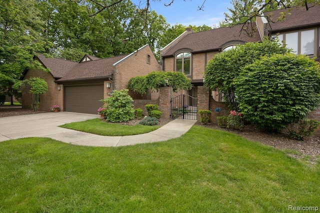 5117 Woodview Ct, Dearborn, MI 48126 - view of front facade featuring brick siding, a front lawn, a garage, and driveway