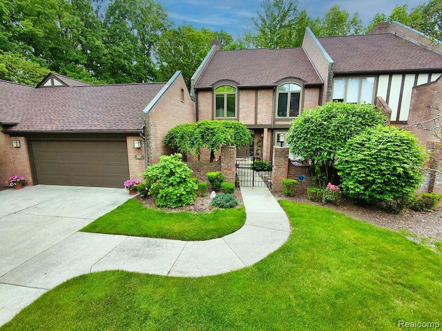 5117 Woodview Ct, Dearborn, MI 48126 - view of front facade featuring brick siding, an attached garage, concrete driveway, and roof with shingles