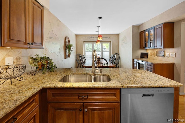 5117 Woodview Ct, Dearborn, MI 48126 - kitchen featuring dishwasher, a sink, light stone counters, and a peninsula