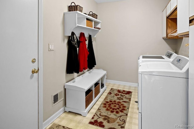 5117 Woodview Ct, Dearborn, MI 48126 - laundry room featuring washing machine and dryer, cabinet space, light flooring, and baseboards
